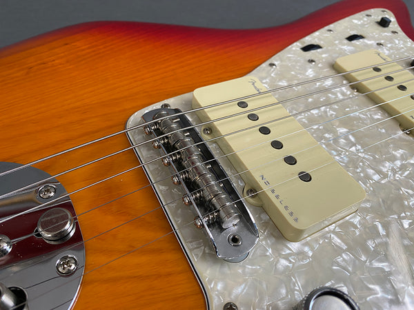 Close-up of Fender Noiseless pickups and bridge on sunburst electric guitar with pearloid pickguard at Coffee House Guitars