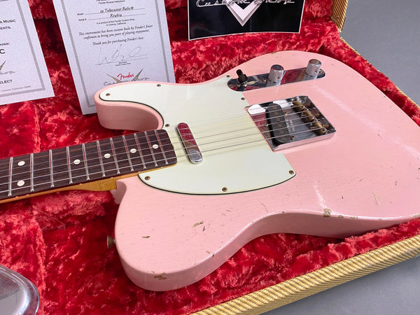Fender Custom Shop 59 Telecaster Relic electric guitar in pink finish with white pickguard resting in red plush guitar case with certificate of authenticity and custom shop paperwork visible