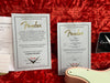 Fender Custom Shop Certificate of Authenticity for limited edition Dealer Select Telecaster and signed certificate for 59 Telecaster Relic model on red plush background with partial view of pink Fender guitar body and mint green pickguard