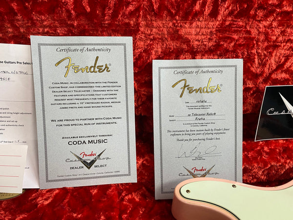 Fender Custom Shop Certificate of Authenticity for limited edition Dealer Select Telecaster and signed certificate for 59 Telecaster Relic model on red plush background with partial view of pink Fender guitar body and mint green pickguard