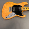 Vintage natural wood finish electric guitar with black pickguard, chrome bridge, and metal control plate with knobs and switches on gray background
