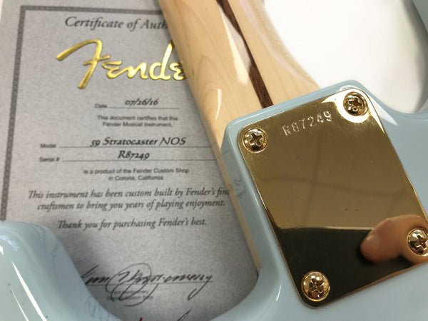 Close-up of Fender 59 Stratocaster NOS guitar neck plate with serial number R87249 and accompanying Certificate of Authenticity from Fender Custom Shop in Corona, California dated 07/26/16.