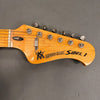 Close-up of Music Man Sabre 1 electric guitar headstock with tuning pegs and logo on natural wood finish