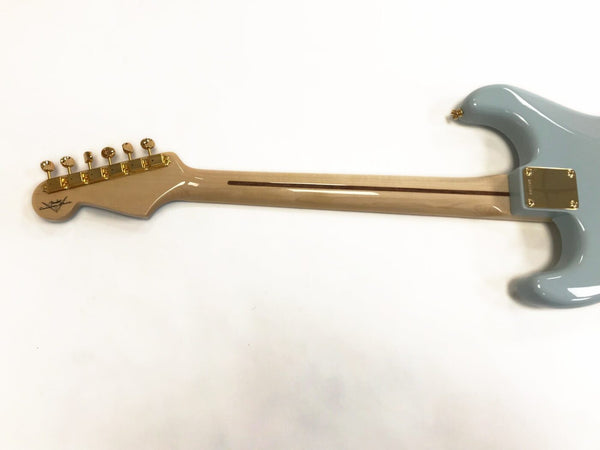 Back view of electric guitar with maple neck, gold tuning pegs, and light blue body showing neck plate and contoured body edge