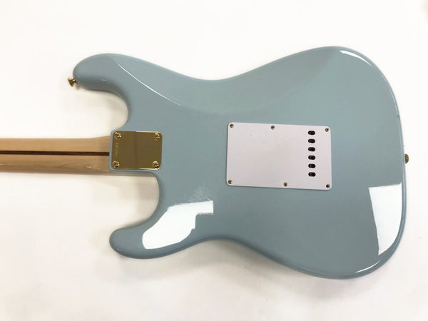 Back view of light blue electric guitar with white backplate and maple neck, gold neck plate and strap button on white background