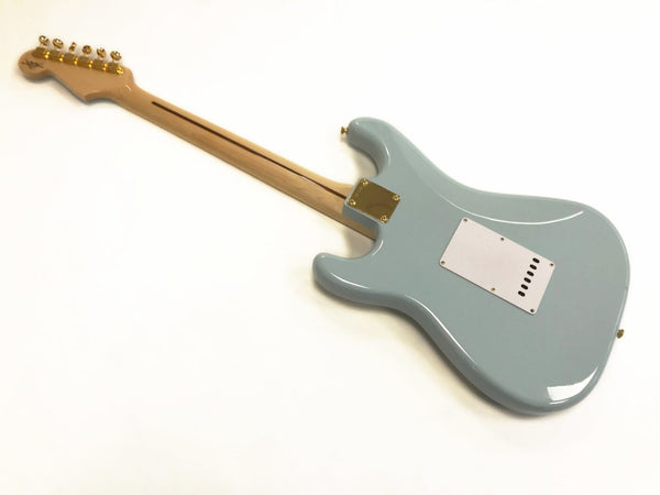 Back view of light blue electric guitar with maple neck and gold hardware on white background, showing body contours and rear cavity plate.