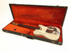 Vintage white electric guitar with Bigsby tremolo in open black hard case lined with red velvet