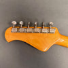 Vintage natural wood guitar headstock with six chrome Music Man tuning pegs on dark gray background