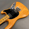 Natural wood finish electric guitar with black pickguard, dual humbucker pickups, chrome bridge, and chrome control knobs on gray background