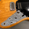 Close-up of natural wood electric guitar body showing chrome bridge, control knobs, toggle switches, and black pickup with black pickguard at Coffee House Guitars