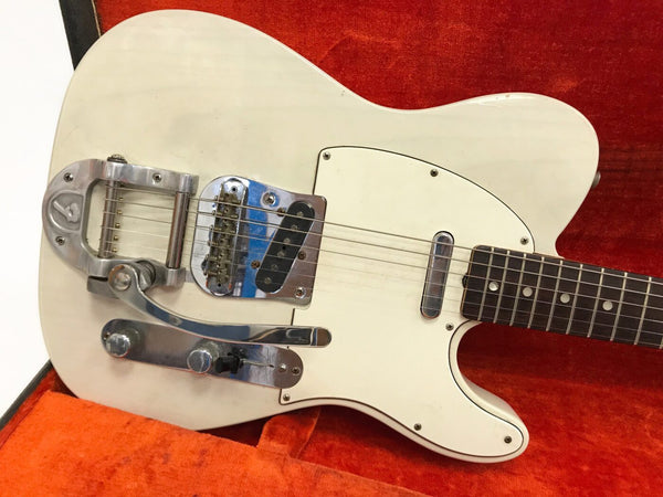 White electric guitar with Bigsby vibrato tailpiece, single-coil pickups, and rosewood fretboard in orange guitar case