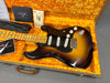 Vintage Fender Stratocaster electric guitar in sunburst finish with maple neck and black pickguard in orange plush-lined hard case with Fender Custom Care documentation and black guitar strap