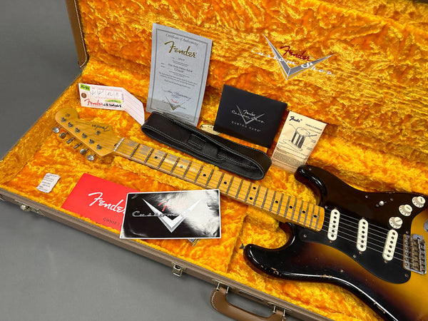 Fender Stratocaster electric guitar in sunburst finish inside vintage orange plush-lined hard case with Fender certificate of authenticity, strap, owner's manual, custom care booklet, and tremolo springs instruction sheet
