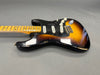 Vintage sunburst electric guitar with maple neck and black pickguard showing worn finish and three single-coil pickups on gray background
