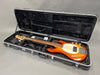Fretless electric bass guitar with sunburst finish in black plush-lined hard case at Coffee House Guitars