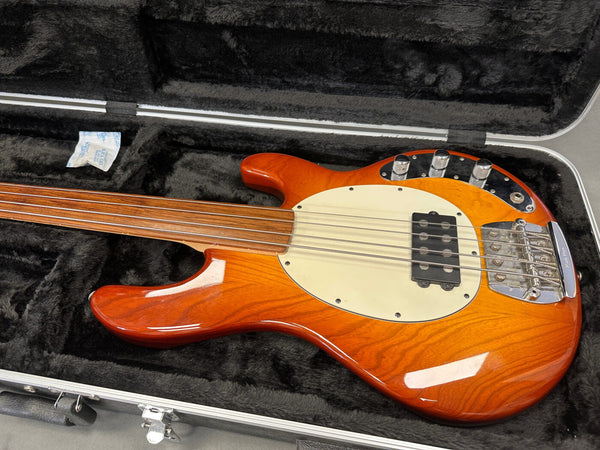 Sunburst finish electric bass guitar with fretless rosewood fingerboard in black plush-lined hard case