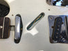 Close-up of white electric guitar body showing pickup cavities with exposed wiring and chrome pickup covers, worn and vintage condition, detailed view of bridge and neck areas