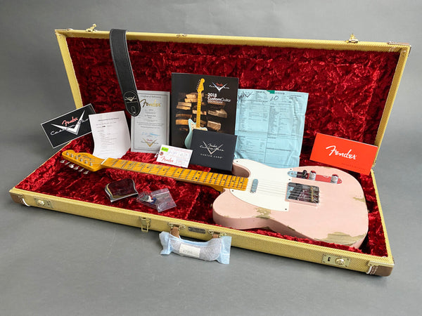 Fender Custom Shop 1991 relic pink electric guitar with maple neck and fretboard in tweed hardshell case with original Fender manuals, certificate of authenticity, custom care booklet, strap, and paperwork on red velvet interior