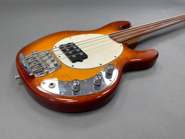 Fretless electric bass guitar with sunburst finish, chrome control knobs, and black pickup on gray background
