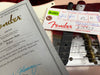 Close-up of Fender Custom Shop certificate of authenticity and Fender tag on 1954 Telecaster Relic electric guitar with serial number R18327 and part number R10327, featuring vintage-style bridge and strings
