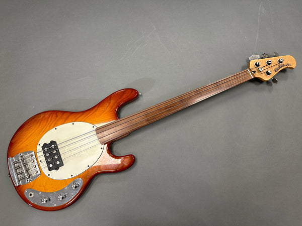 Fretless electric bass guitar with sunburst finish and wooden neck on gray background, Coffee House Guitars product listing