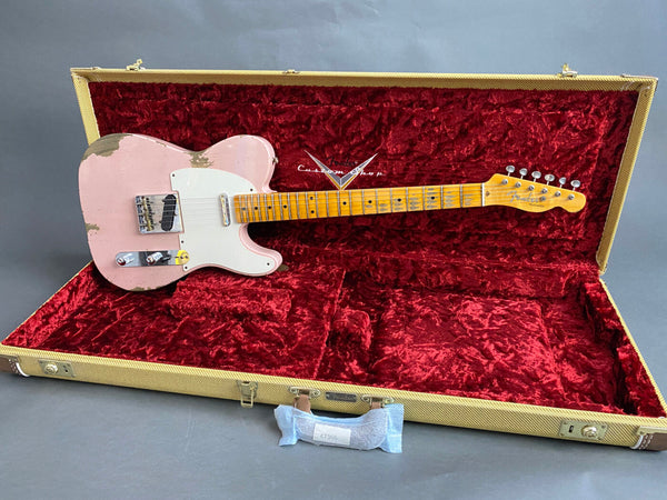 Fender Custom Shop vintage pink relic Telecaster electric guitar with maple neck and white pickguard in open tweed case with red plush interior.
