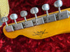 Close-up of vintage Fender Custom Shop guitar headstock with six vintage tuning pegs on red plush case lining