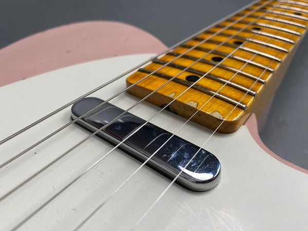 Close-up of vintage electric guitar with white and pink body, chrome pickup, and worn maple fretboard at Coffee House Guitars