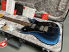 Fender electric guitar in blue burst finish with rosewood fretboard and dual humbucker pickups in a hardshell case with Fender setup and warranty documents, included tools, and Friedrich Cozy plush interior lining for protection.