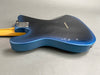 Back view of blue electric guitar body with visible string ferrules and neck joint plate on grey background