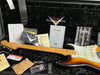 Fender Custom Shop sunburst electric guitar with maple neck and fretboard inside black plush guitar case, accompanied by Fender certificate of authenticity, Fender lacquer finishes care booklet, pre-sales checklist, guitar strap, guitar picks, strings, and user manuals.