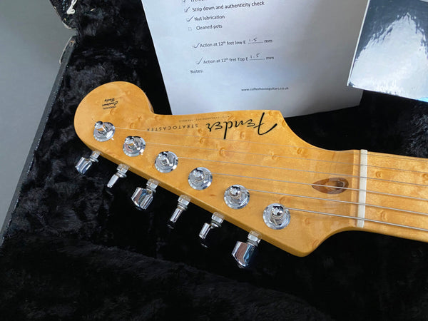 Fender Stratocaster guitar headstock with chrome tuning pegs and birdseye maple neck in black plush guitar case with inspection checklist from Coffee House Guitars