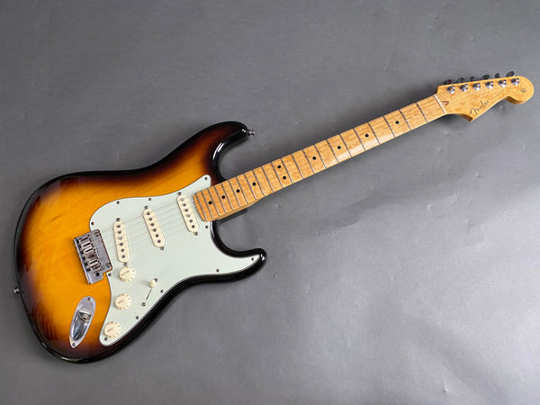 Fender Stratocaster electric guitar with sunburst finish, maple fretboard, three single-coil pickups, and vintage-style tremolo bridge on gray background