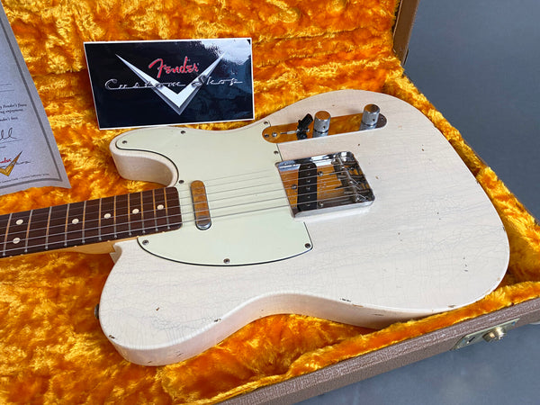 Fender Custom Shop white vintage Telecaster electric guitar with worn finish and maple neck inside orange plush-lined hard case with Fender certificate.