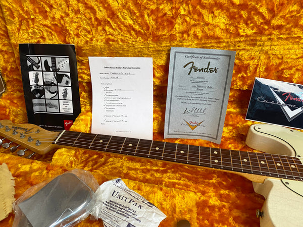 Fender Telecaster guitar neck and body in orange plush case with Fender owner's manual, Coffee House Guitars pre-sales checklist, Fender certificate of authenticity, and packaging materials