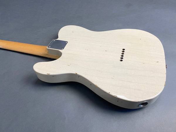 Vintage white electric guitar body with natural wood neck and metal neck plate, worn and aged finish with visible cracks and chips