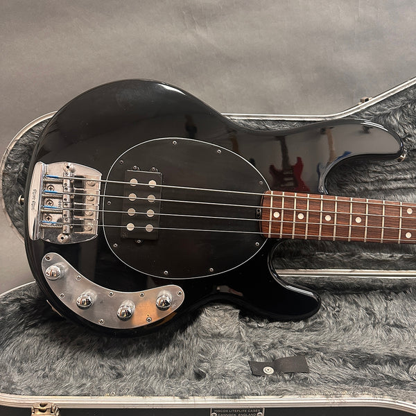 Black electric bass guitar with rosewood fretboard and chrome hardware in gray plush-lined hard case