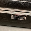 Close-up of Hiscox Liteflite guitar case label showing manufacturing details and contact information from Cannock, England.