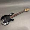 Black electric bass guitar with rosewood fretboard and maple headstock featuring four tuning pegs, chrome bridge, and control knobs on a gray background
