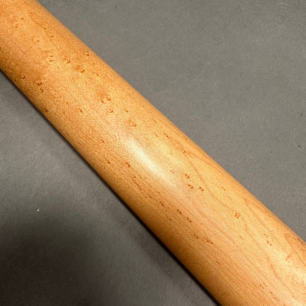 Close-up of birdseye maple guitar neck on gray background, smooth finish, Coffee House Guitars product detail