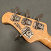Close-up of natural wood guitar headstock with four chrome tuning pegs and "Made in San Luis Obispo California USA" stamp on back