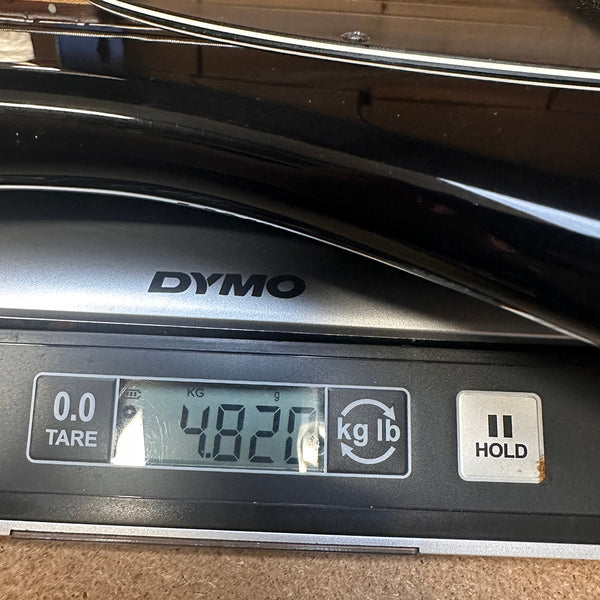 Dymo digital scale showing weight of 4.82 pounds for a guitar at Coffee House Guitars