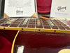 Close-up image of Gibson Custom Murphy Lab guitar fretboard and body with detailed aging finish and Gibson Custom product information cards in the background.