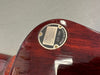 Close-up of Gibson Custom logo plate on back of vintage red electric guitar body showing "Est. 1894 Made in U.S.A." engraving