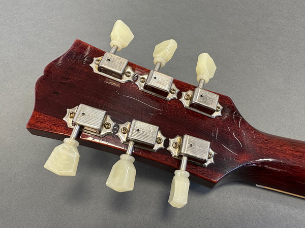 Vintage guitar headstock back showing six vintage Kluson Deluxe tuning pegs with cream plastic buttons on dark wood guitar neck