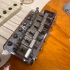 Close-up of vintage Fender electric guitar bridge and strings on sunburst finish body