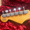Fender Custom Shop Limited Edition guitar headstock with vintage tuners on red plush case interior