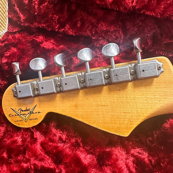 Fender Custom Shop Limited Edition guitar headstock with vintage tuners on red plush case interior
