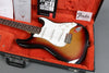 Fender Stratocaster electric guitar in sunburst finish in open black hard case with orange plush interior and Fender paperwork and booklet