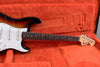Fender Stratocaster electric guitar with sunburst finish and white pickguard in orange plush-lined guitar case